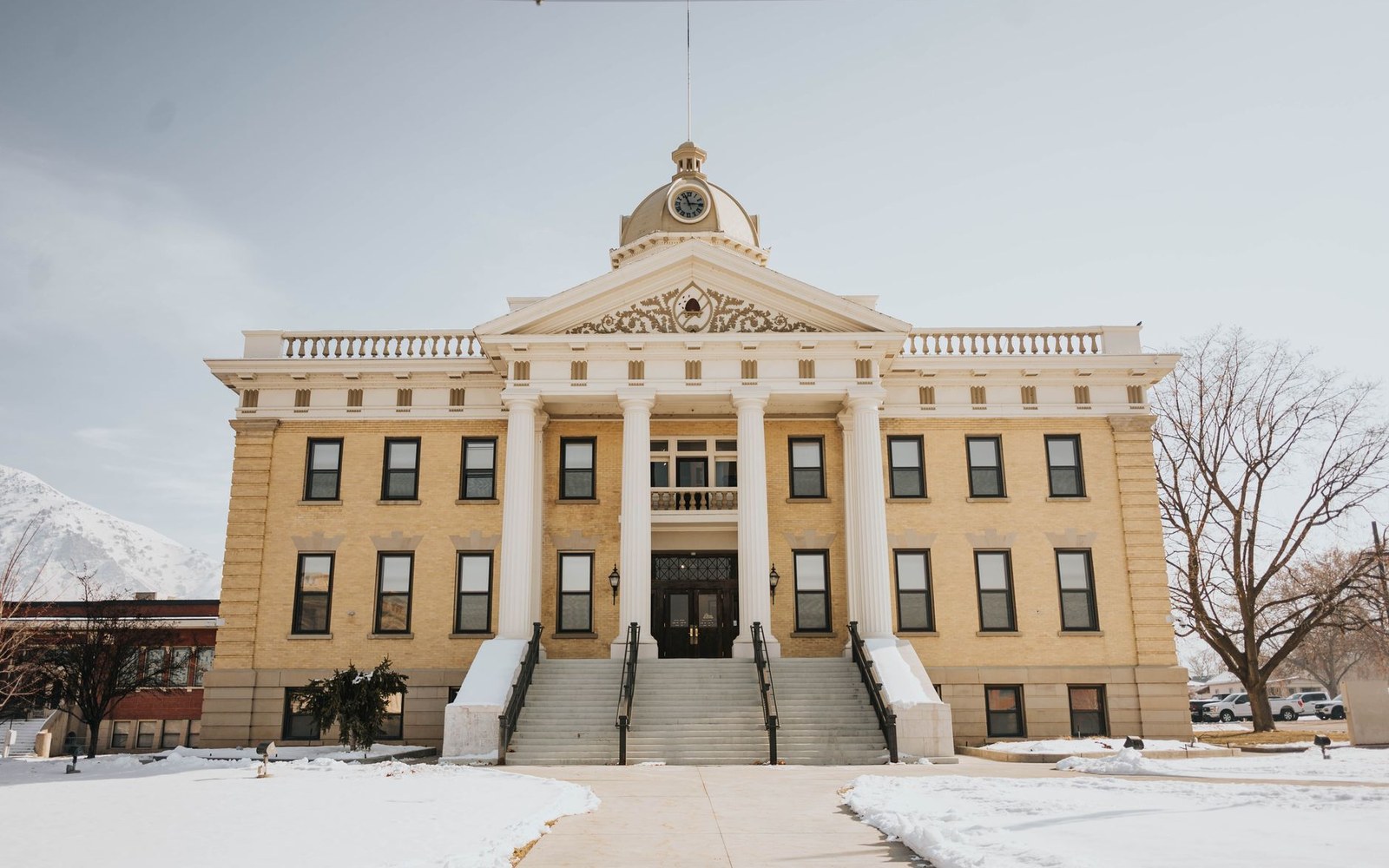 Domed courthouse building with white columns and snow-covered grounds in front