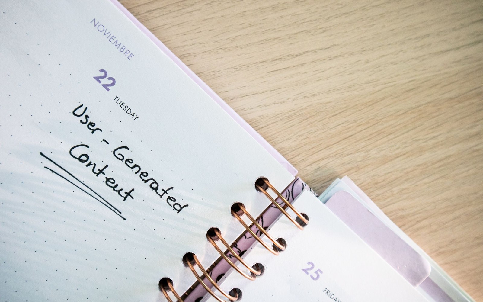 Spiral-bound planner page with "User-Generated Content" handwritten under the date entry